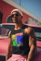 Man wearing a black tank top with colorful graphics and text, sitting on a red car.