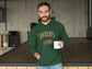 Man wearing a green hoodie with &