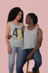 Two people wearing matching gray tank tops with a design on a pink background