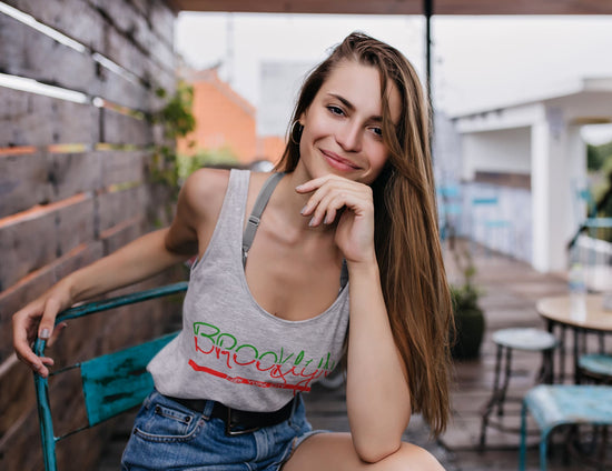 Woman sitting outdoors in a casual setting with a relaxed posture