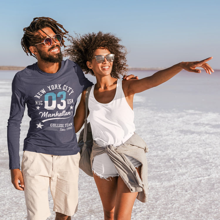 Two people walking on a salt flat with clear blue skies.