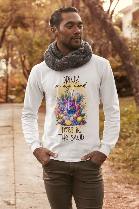 Man wearing a white long-sleeve shirt with a colorful graphic and text, standing outdoors.