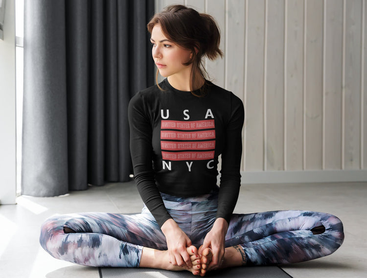 Woman sitting in a yoga pose wearing a black sweatshirt with &
