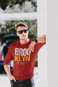 Man wearing a red t-shirt with &