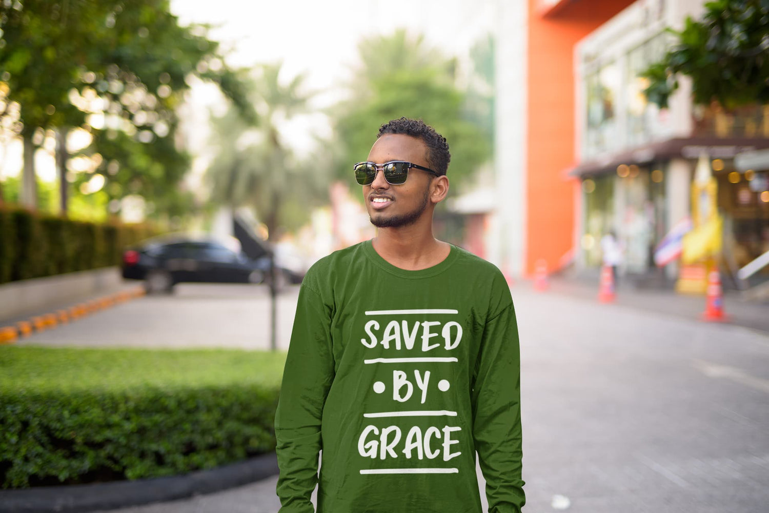 Man wearing a green sweatshirt with &