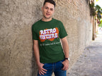 Man wearing a green t-shirt with 'Retro Future' design leaning against a stone wall.