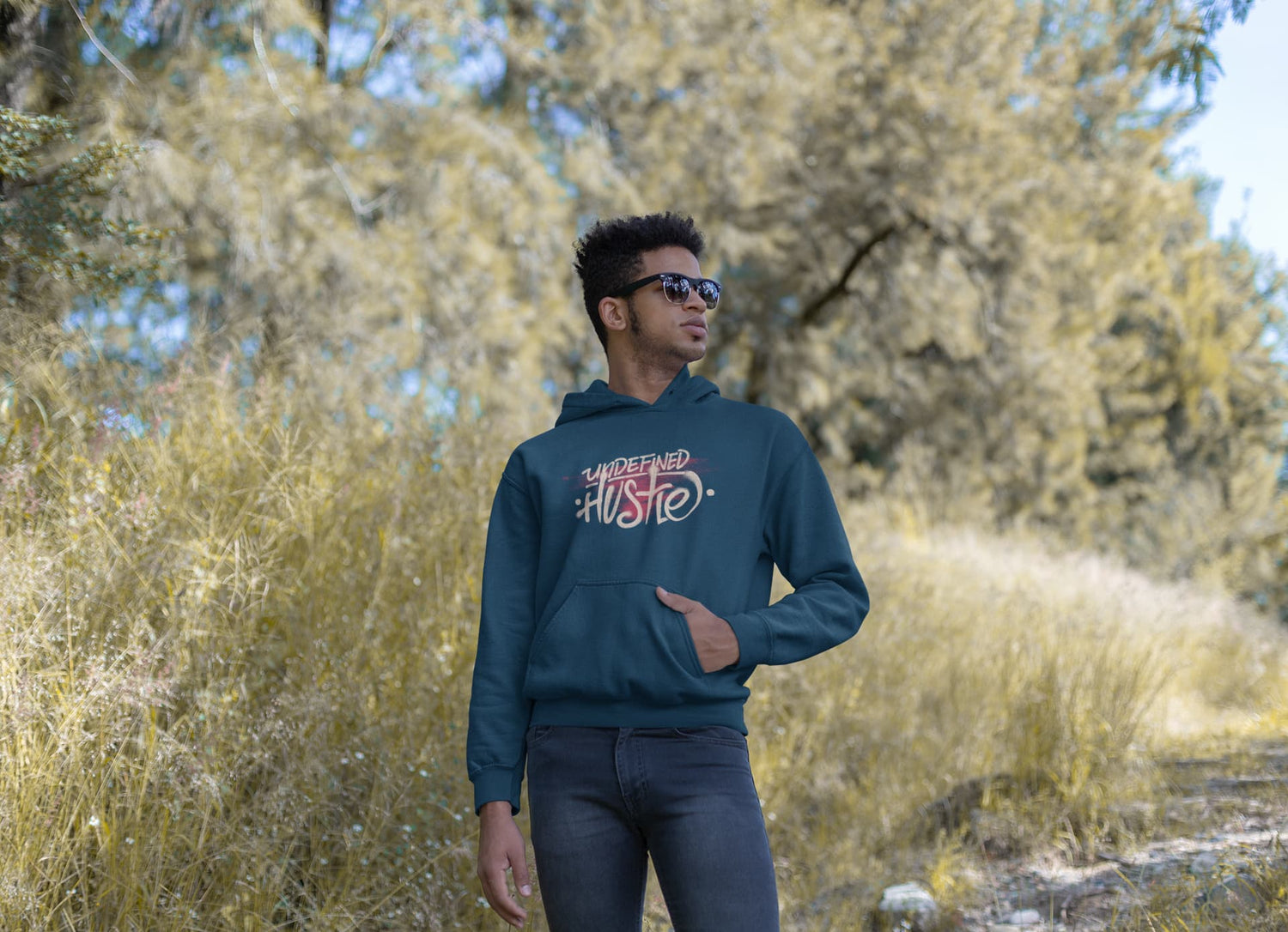 Person wearing a hoodie with text in a natural setting