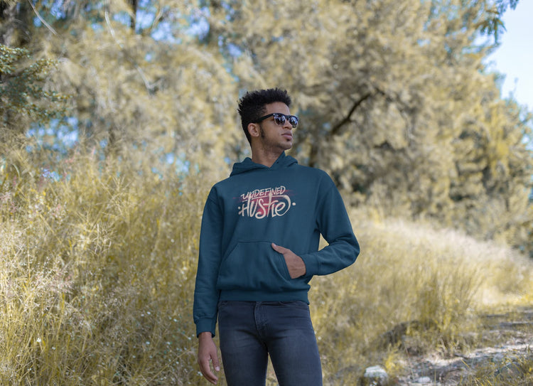 Person wearing a hoodie with text in a natural setting
