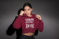 Person wearing a maroon hoodie with &