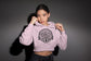 Woman wearing a pink hoodie with &