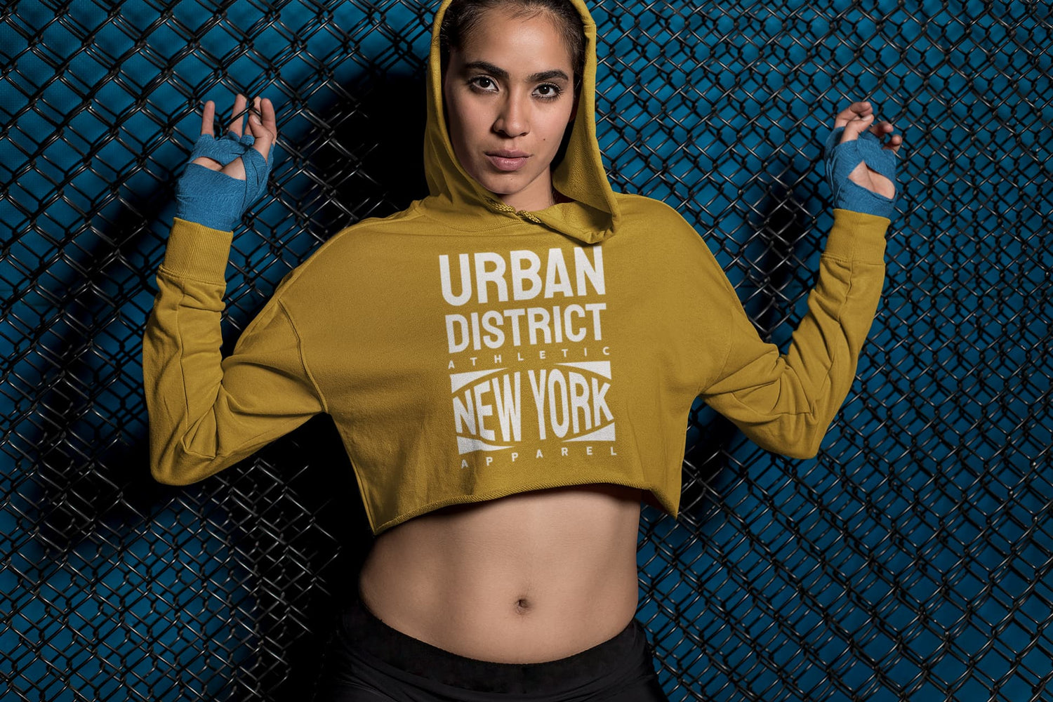 Person wearing a mustard yellow hoodie with &