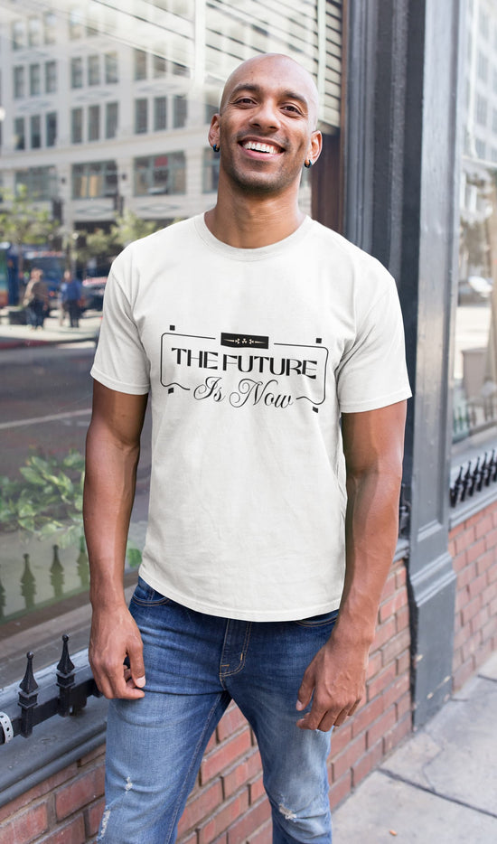 Man wearing a white t-shirt with text standing on a city street.