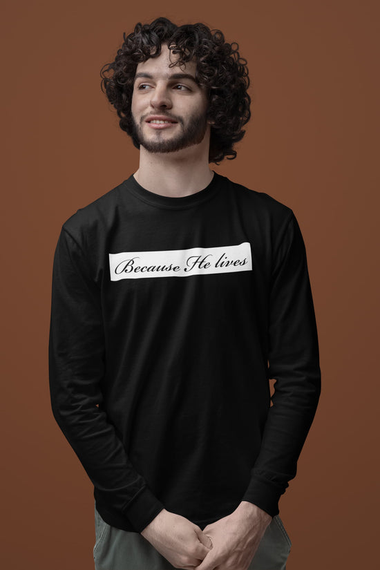 Man wearing a black long-sleeve shirt with text on a brown background