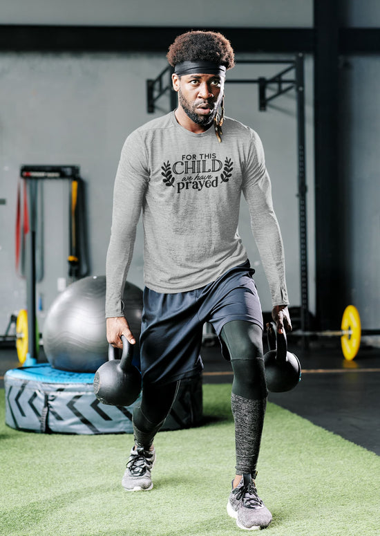 Man exercising with kettlebells in a gym setting