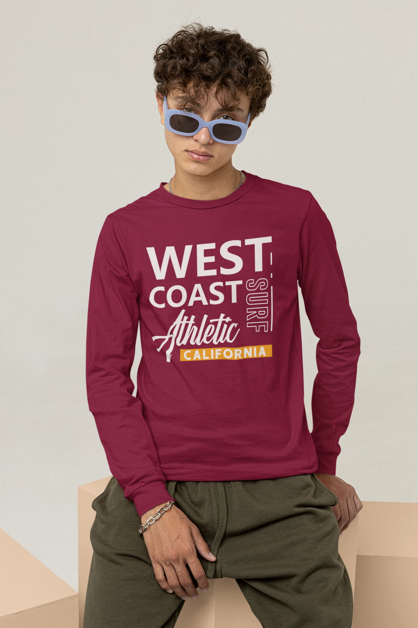 Person wearing a maroon long-sleeve shirt with &