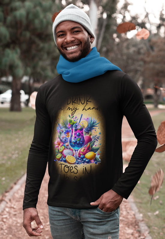 Man wearing a black long-sleeve shirt with a colorful graphic and text, standing outdoors.