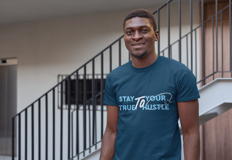 Man wearing a blue t-shirt with text standing in an indoor setting