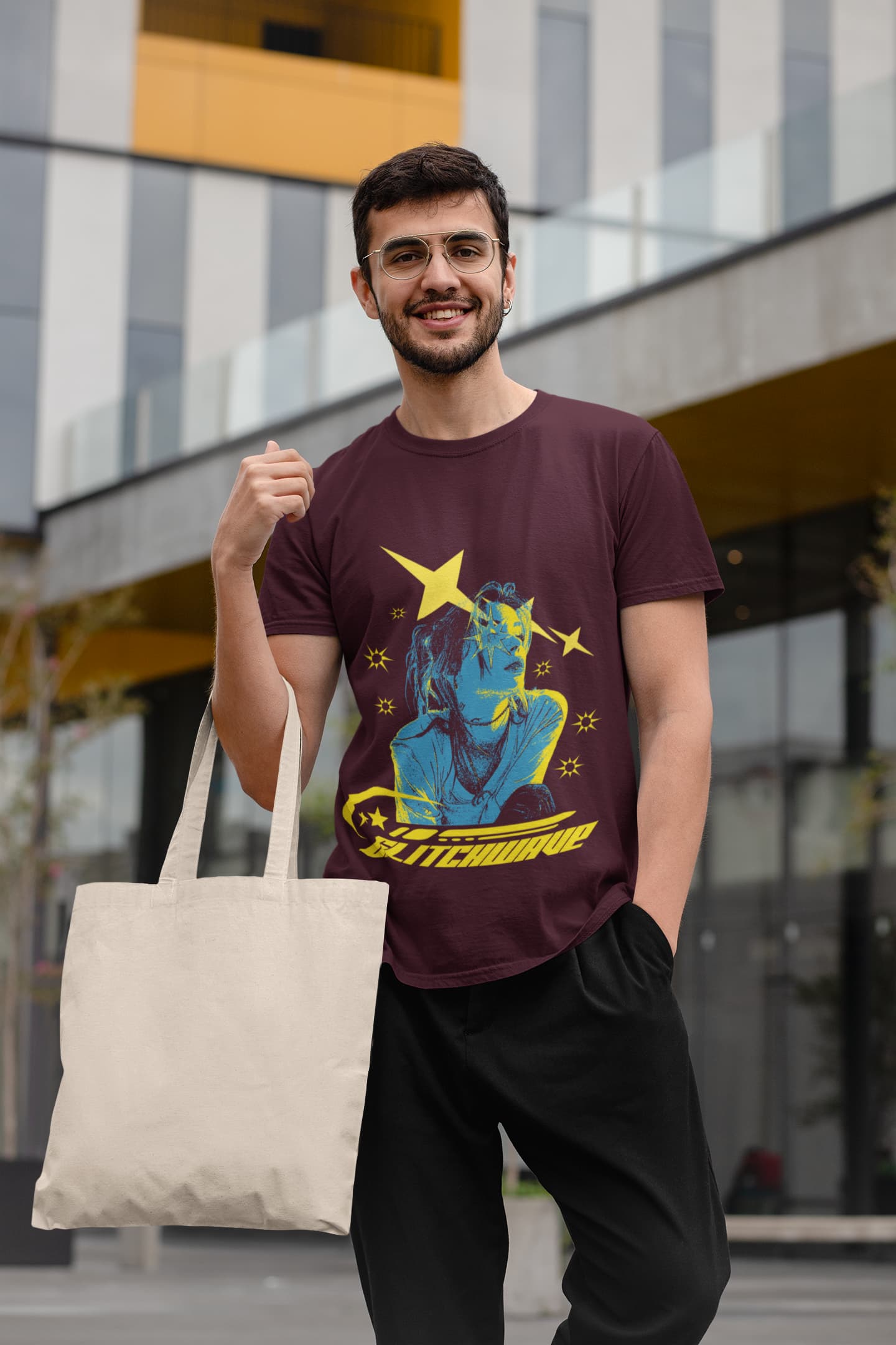 Man wearing a graphic t-shirt holding a tote bag outdoors