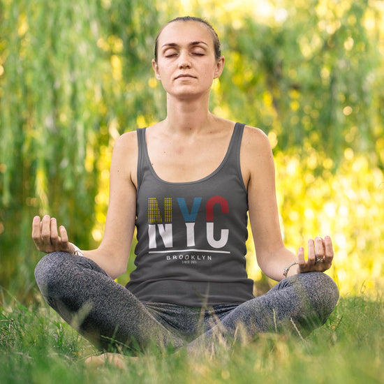 Woman meditating outdoors wearing an NYC tank top.