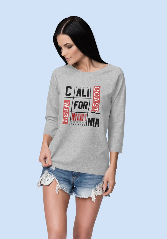 Woman wearing a gray sweatshirt with text design on a light blue background