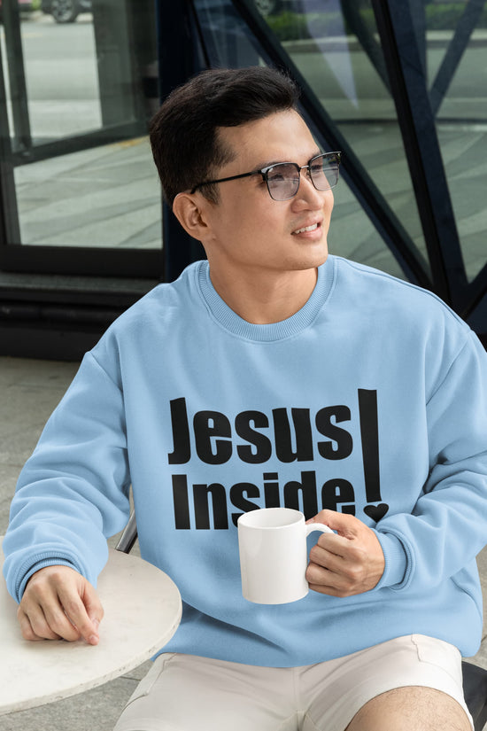 Man wearing a light blue sweatshirt with &