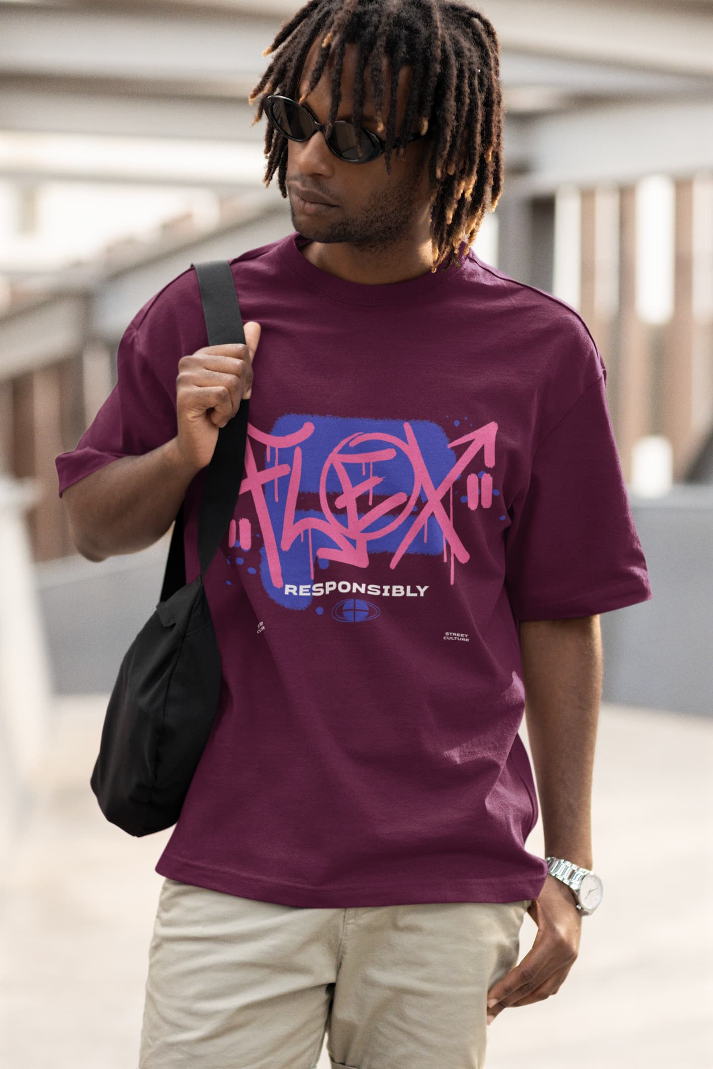 Man wearing a purple t-shirt with 'FLEX RESPONSIBLY' text, holding a black bag.