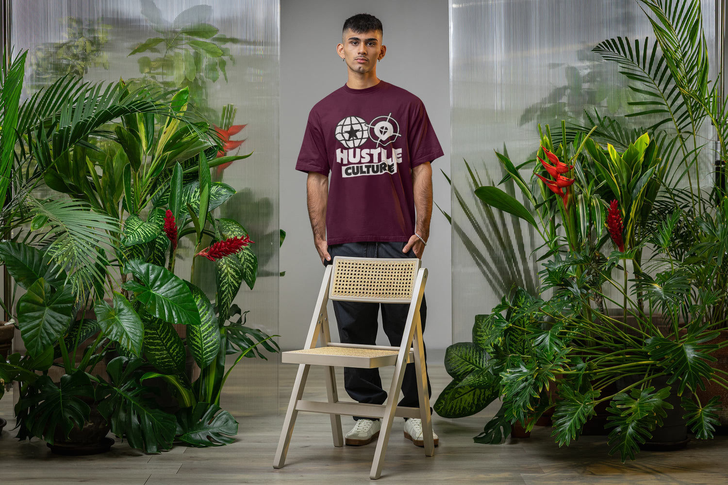 Man standing with a chair in a room with plants