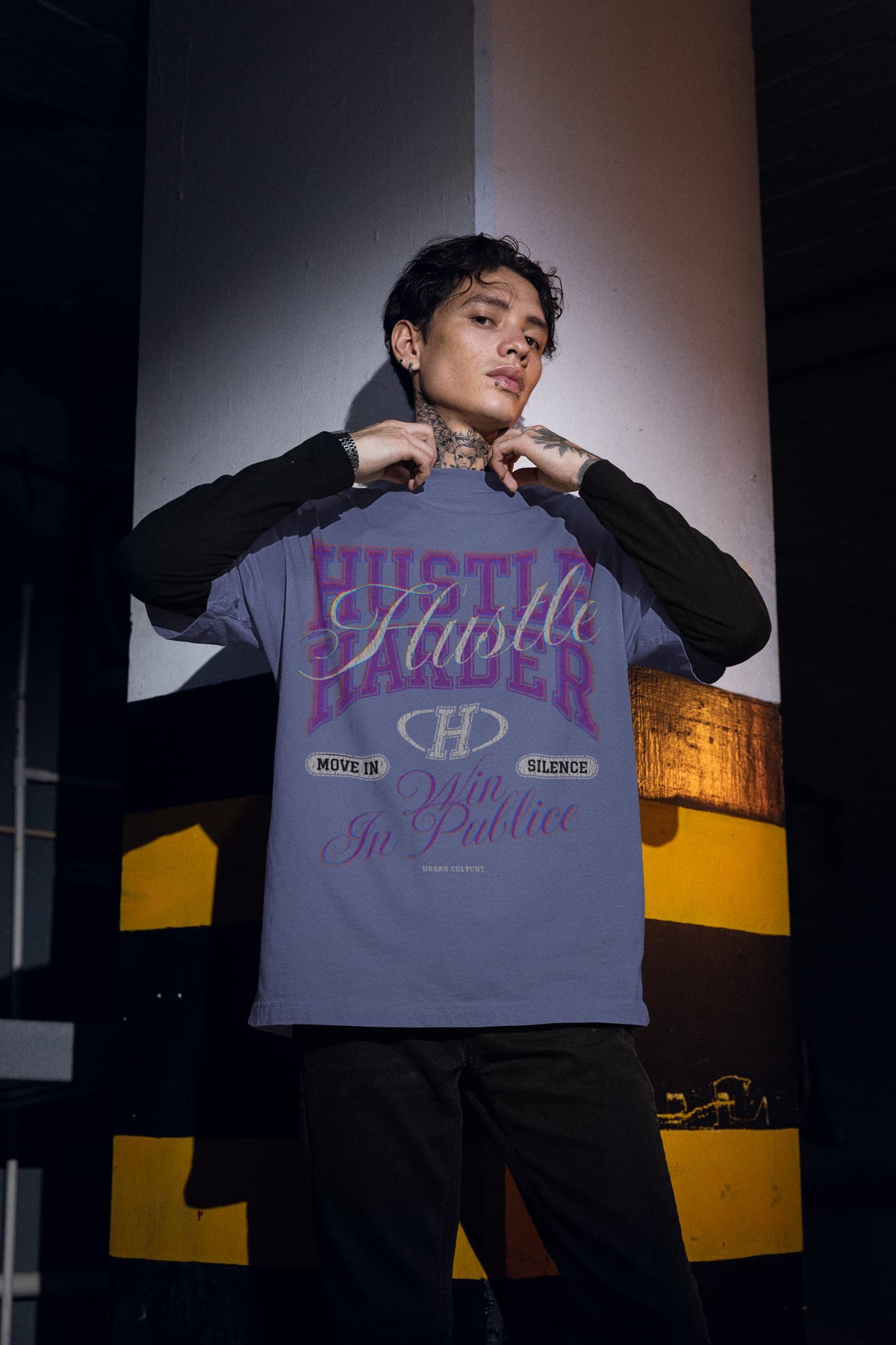 Person wearing a t-shirt with motivational text in an urban setting