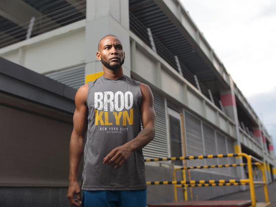 Man wearing a gray sleeveless shirt with &