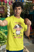 Person wearing a yellow t-shirt with a cow graphic and text, holding a cup outdoors.