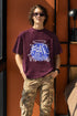 Person wearing a purple t-shirt with &