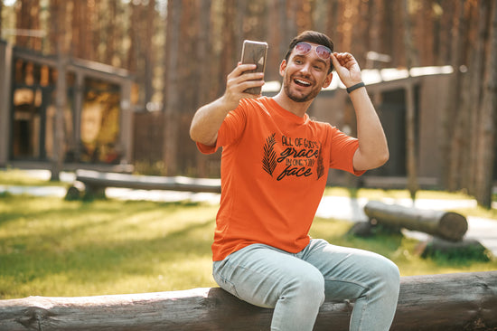 Man taking a selfie outdoors in a forested area
