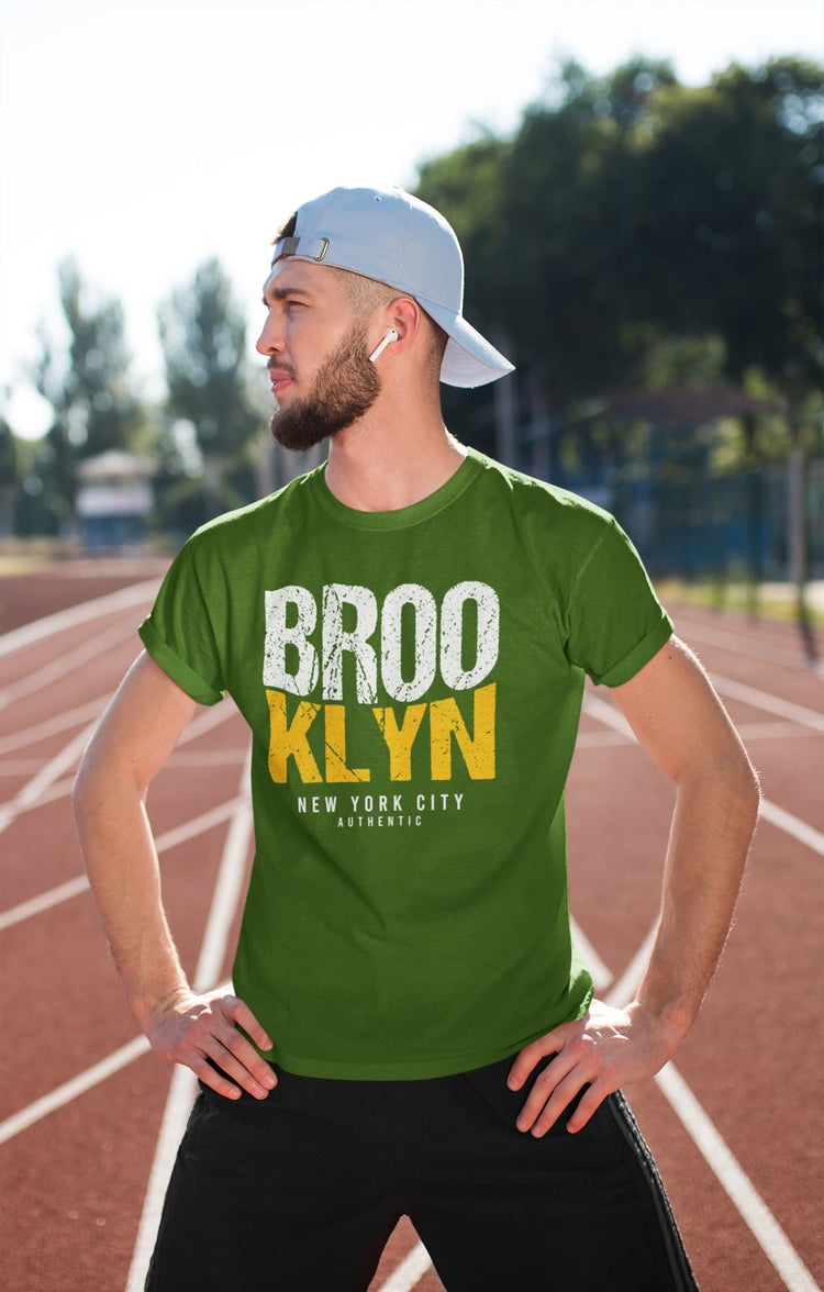 Man wearing a green t-shirt with &
