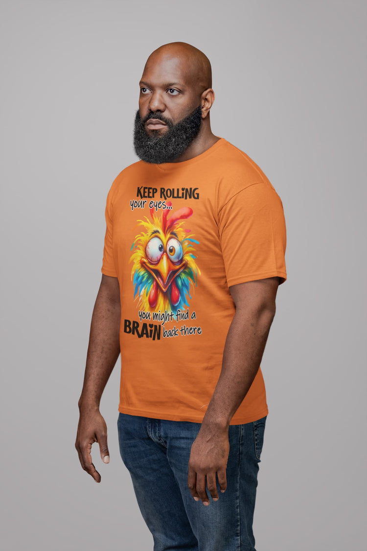 Man wearing an orange t-shirt with a colorful rooster graphic and text.