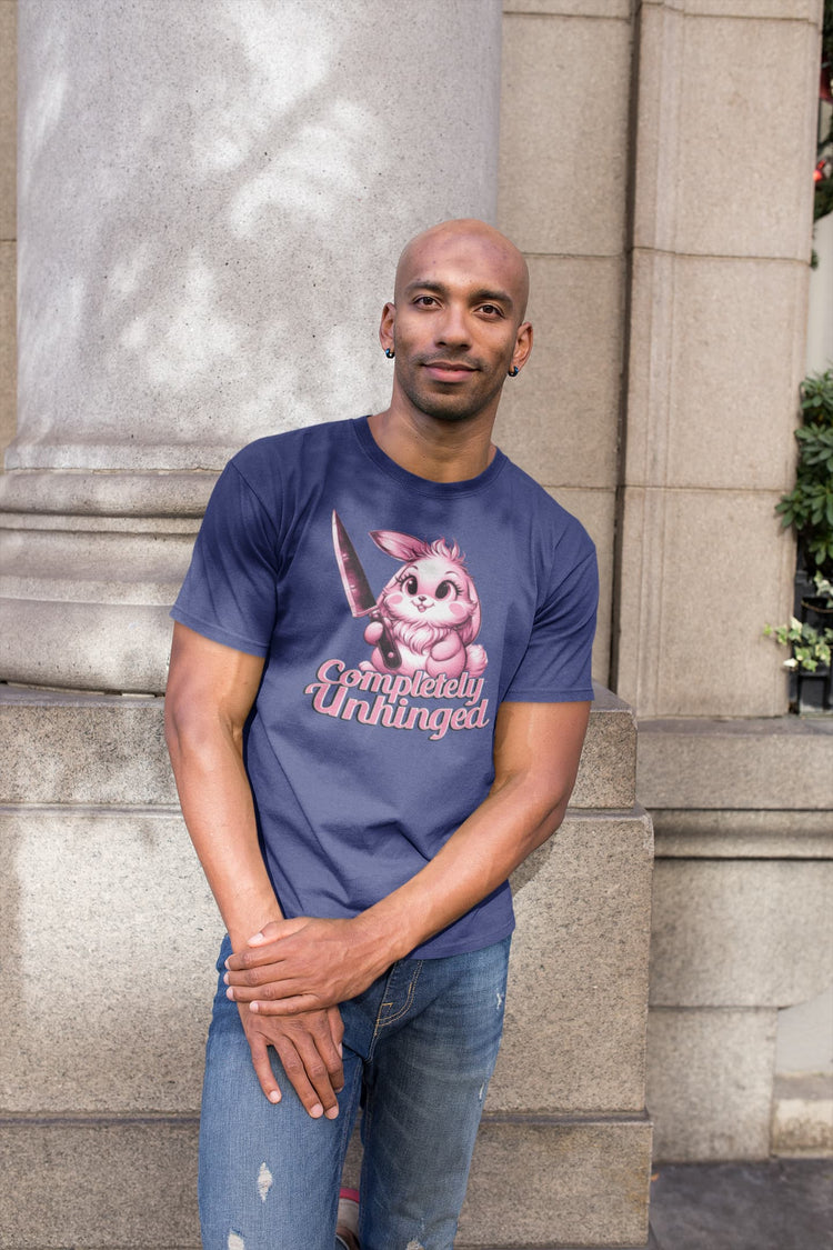 Man wearing a blue t-shirt with a graphic design standing outdoors.