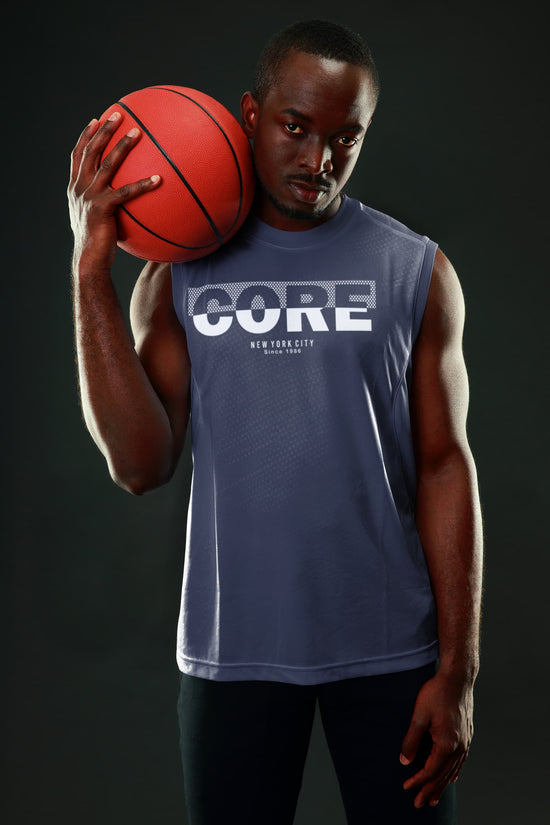 Man holding a basketball wearing a sleeveless shirt with &