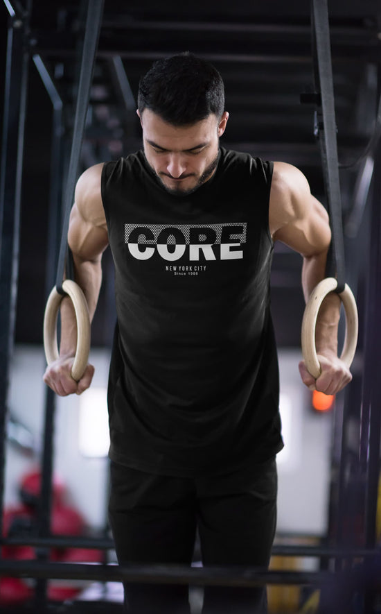 Man exercising with rings wearing a black &