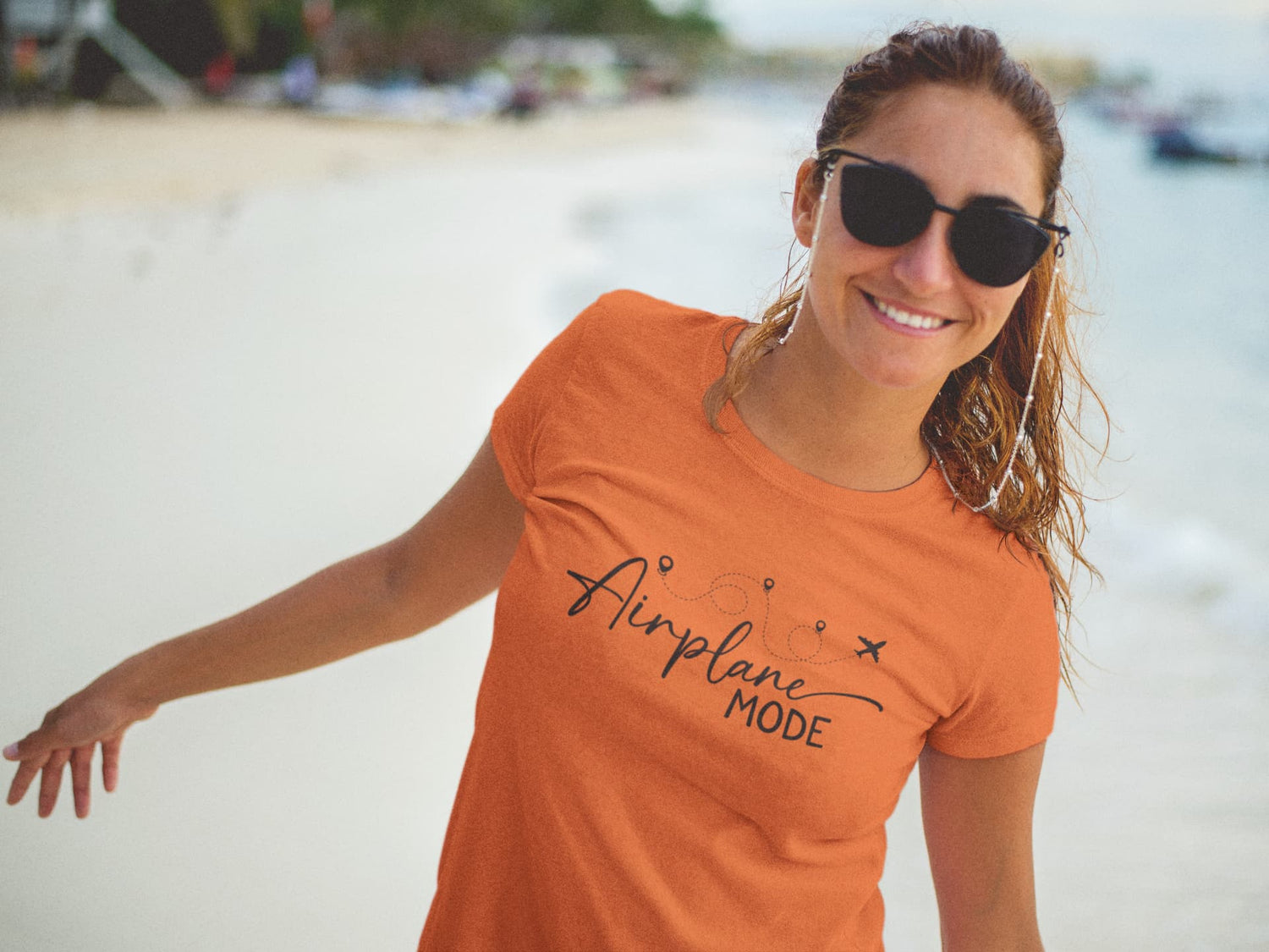 Woman wearing an orange t-shirt with &