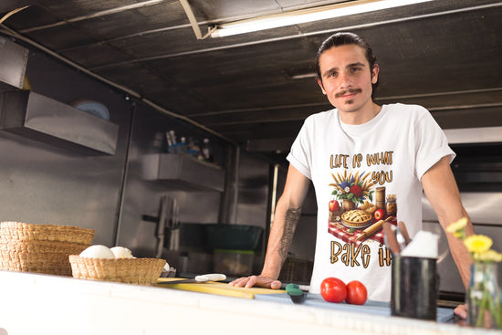 Man standing in a kitchen with a white t-shirt featuring a graphic design.