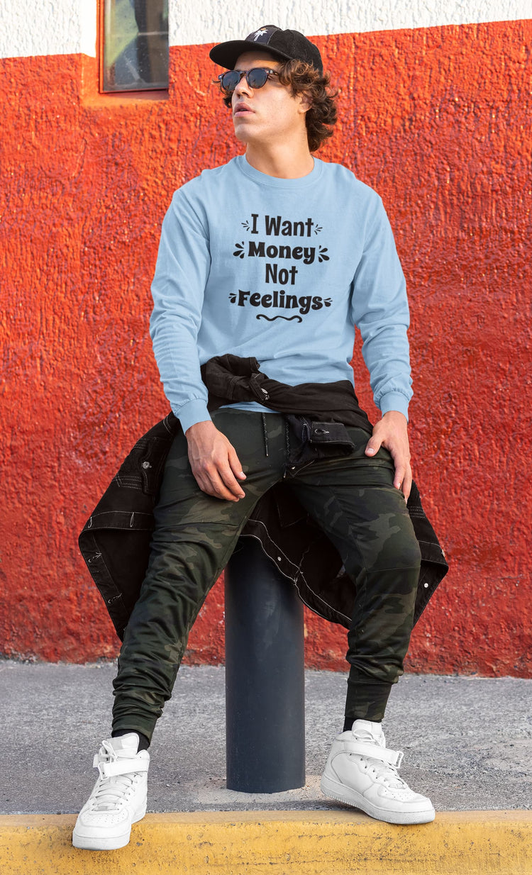 Person wearing a light blue sweatshirt with text, sitting against a red wall.