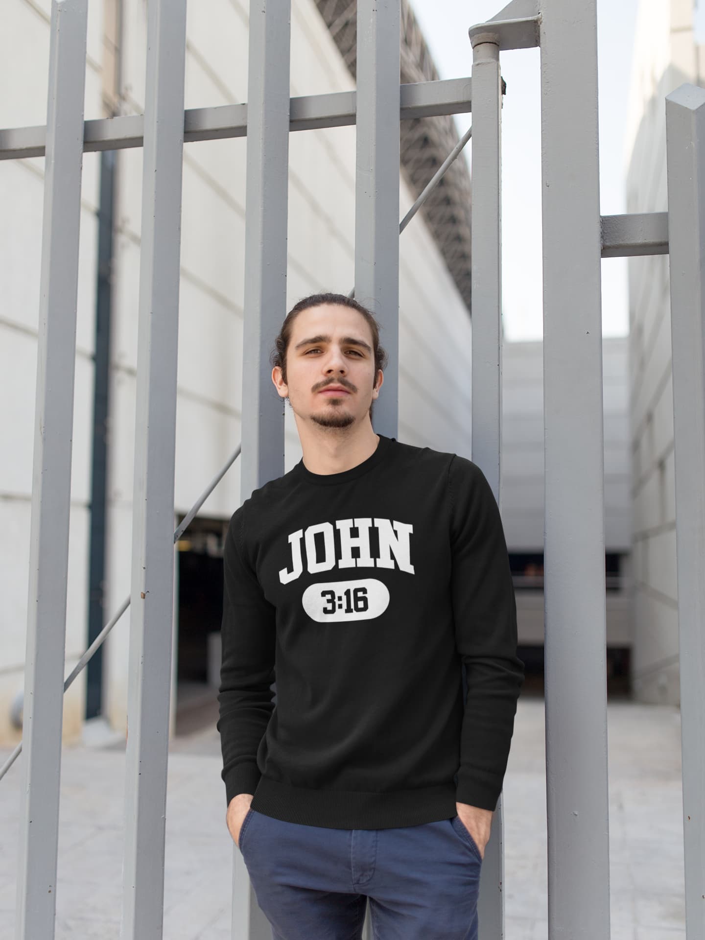 Man wearing a black sweatshirt with &