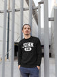 Man wearing a black sweatshirt with &