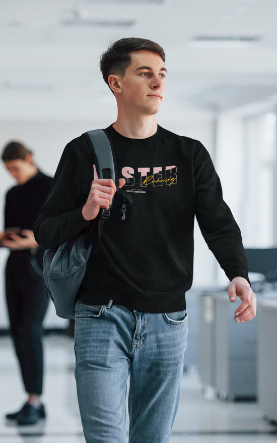 Person wearing a black sweatshirt with text, holding a backpack in an indoor setting.