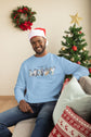 Man wearing a light blue sweatshirt with &