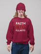 Person wearing a maroon sweatshirt with &