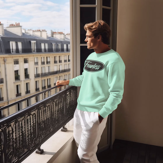 Man wearing a light blue sweatshirt with &