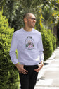 Man wearing a light blue sweatshirt with a graphic design outdoors