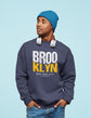 Man wearing a navy sweatshirt with &