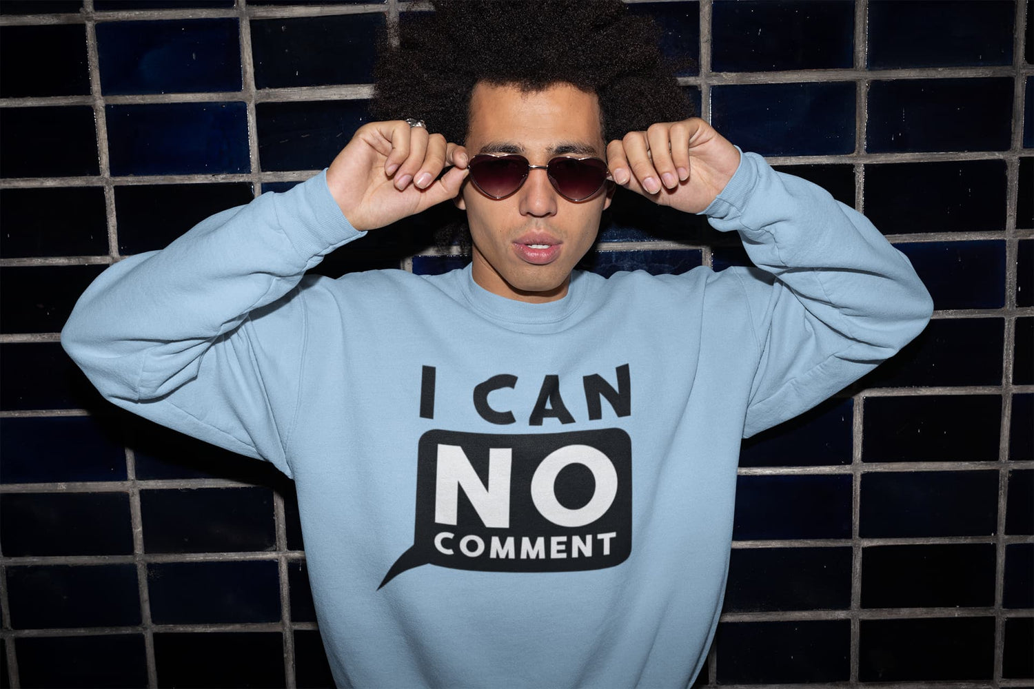 Person wearing a light blue sweatshirt with &