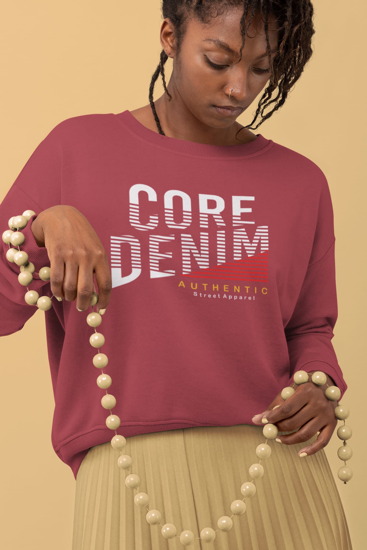 Person wearing a maroon sweatshirt with &